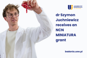 Szymon Juchniewicz of Wroclaw University of Economics and Business has received funding under the NCN MINIATURA programme. He is pictured wearing a white lab coat, with a laboratory in the background.